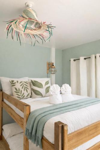 a bedroom with a large bed with white pillows at Bijunas Homestay in General Luna