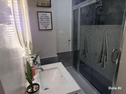 a bathroom with a sink and a shower at Prime World District Condo in Pajak