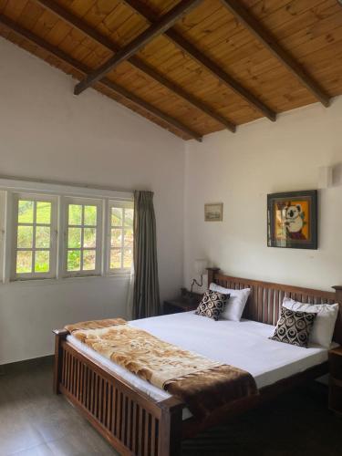 a bedroom with a large bed in a room at Whispering Hills in Nuwara Eliya