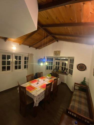 a dining room with a table and chairs at Whispering Hills in Nuwara Eliya