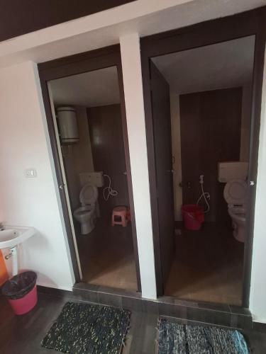 a bathroom with two toilets in a room at AFIYA HOME STAy in Kodaikānāl