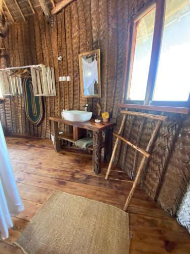 a bathroom with a sink and a mirror in a room at Baobab Lagoon in Mtende