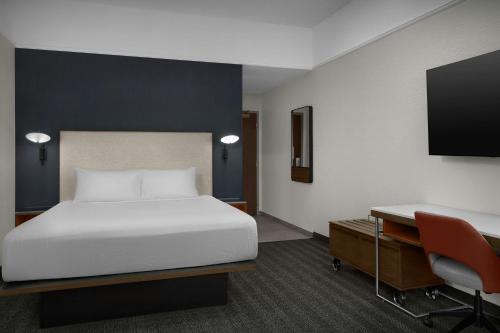 a hotel room with a bed and a desk at Courtyard Danville in Danville