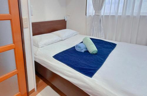 a small bed with a blue towel on it at 池袋1F 2bedrooms Suite Cozy for 1-4 guests in Tokyo