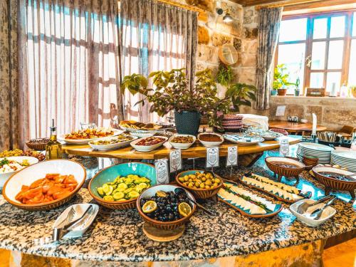 a table filled with plates and bowls of food at Atilla's Cave Hotel in Nevşehir