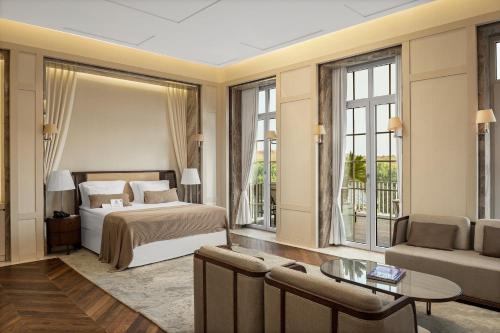 a bedroom with a bed and a living room at Kemer Country Hotel İstanbul in Istanbul