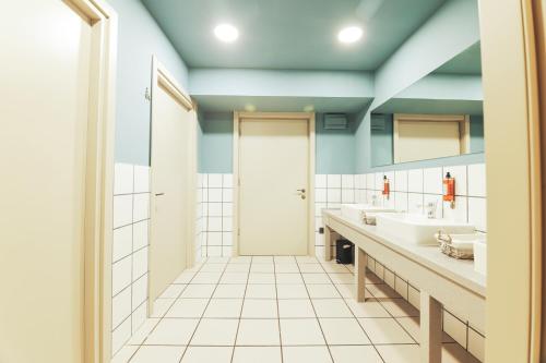 a bathroom with two sinks and a shower at King Tamar Hotel By Luxuria Hotels in Tbilisi City