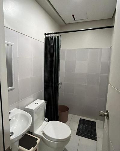 a bathroom with a toilet and a sink at MERE Suite Davao- One Lakeshore behind SM Lanang in Davao City
