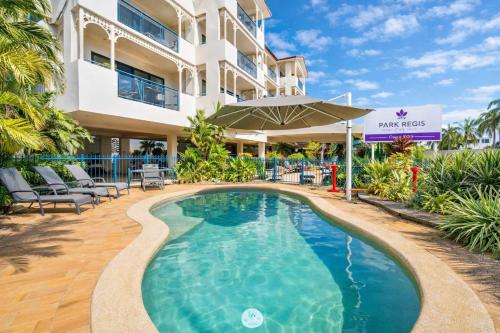 a swimming pool in front of a building at Coastal Breeze Studio Near Stadium, Ferry Marina in Townsville