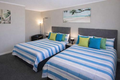 two beds sitting next to each other in a room at Coastal Breeze Studio Near Stadium, Ferry Marina in Townsville