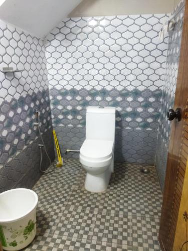a bathroom with a toilet and a sink at Sree durga Villa Homestay in Kodoth
