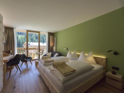 Postel nebo postele na pokoji v ubytování Hotel Vajolet