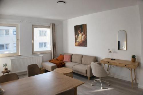 a living room with a couch and a table at Rue118 in Essen