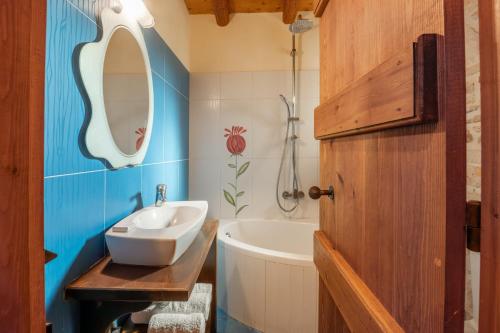 a bathroom with a sink and a bath tub at Grantzaos Villas in Laganas