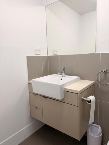 a bathroom with a sink and a mirror at TJ Homes in Ross Island