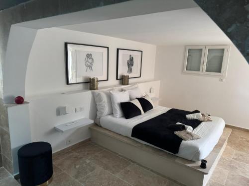 a bedroom with a bed with a dog sitting on it at Suite Prestige in Codolet