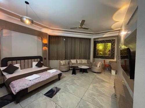 a bedroom with a bed and a living room at GardenView Hotel and Resort in Dhantori