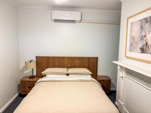 a small bedroom with a bed with aburning at Saltbush Cottage in Broken Hill