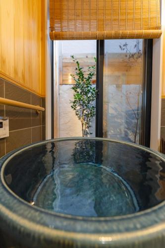 a large bath tub in a bathroom with a window at Kyoto Amazing The Wizarad of Oz in Kyoto