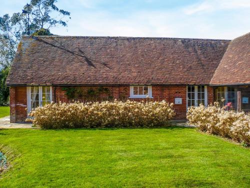 a brick house with a grass yard in front of it at Oaklands Farm - Cottage 5 in Broughton