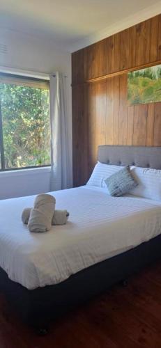 a bedroom with a bed with two pillows and a window at Holiday Home in Warrnambool in Warrnambool