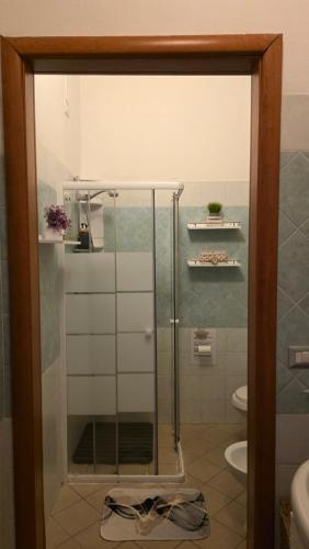 a shower with a glass door in a bathroom at Casa Nicole in Assemini