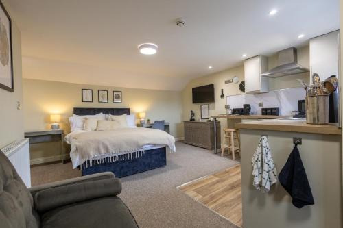 a large bedroom with a bed and a kitchen at Curzon St Aparthotel in Derby