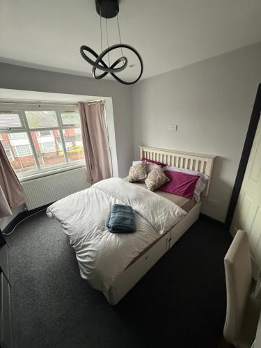 a bedroom with a bed with pillows on it at North Birmingham in Holly Lane