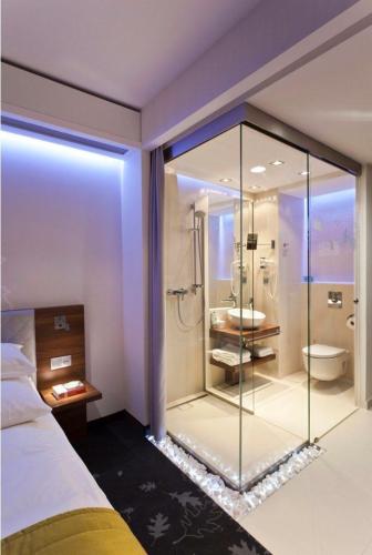 a bathroom with a glass shower with a toilet at Airport Hotel Vella VILLA By Corporate Group Delhi IGI Airport Terminal 3 With Free Airport Pickup in New Delhi