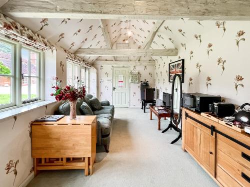 a living room with a couch and a table at Cottage 3 - Uk46609 in Broughton