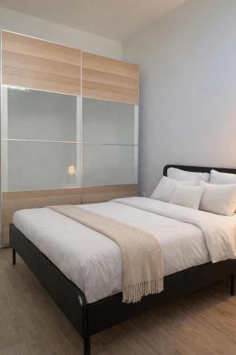 a bedroom with a large bed with white pillows at Zena Park - Near Lisbon in Odivelas