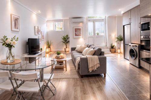 a living room with a couch and a table at Zena Park - Near Lisbon in Odivelas