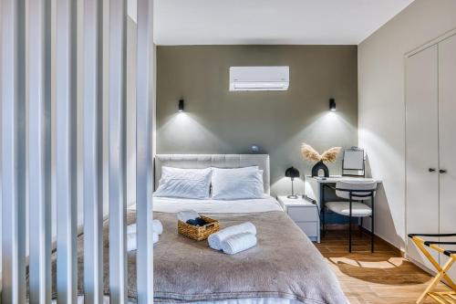 a bedroom with a bed and a desk in it at Modern City Studio with Balcony Columbus Apartment in Chios