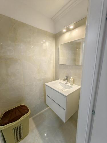 a white bathroom with a sink and a mirror at evaxila papaflessa 机场附近 in Glyka Nera