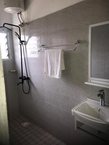 a bathroom with a sink and a white towel at Alberjah Hotel in Atimpoko