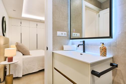 a bathroom with a sink and a bedroom with a bed at Malagueta Loft & Sea in Málaga