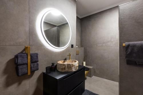 a bathroom with a sink and a mirror at Emerald Suite Design in Neumünster in Neumünster