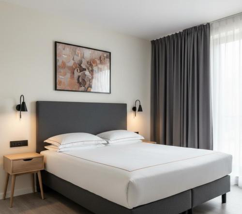 a bedroom with a large white bed and a window at hayal hotel in Tokat