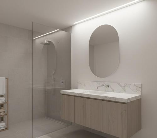 a bathroom with a sink and a shower and a mirror at hayal hotel in Tokat