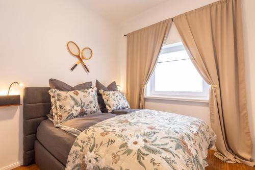 a bedroom with a bed and a large window at Emerald Suite Design in Neumünster in Neumünster