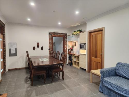a living room with a table and a blue couch at Sunset Hues -Enjoy Peace & Nature in Norton Summit