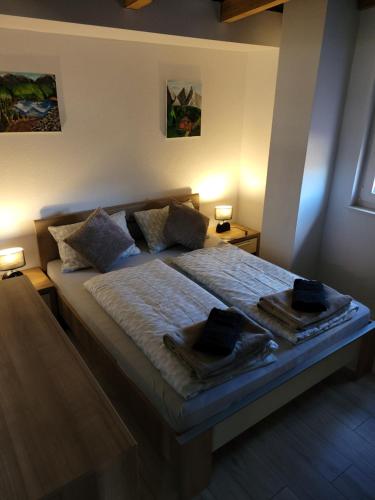 a bedroom with a bed with two towels on it at Stan na dan BOVKA in Široki Brijeg