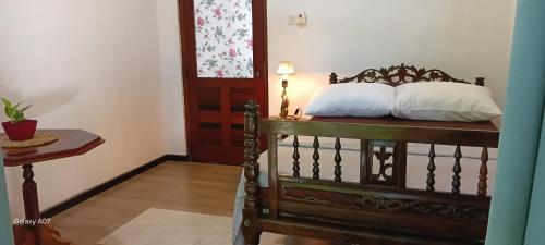a bed with two pillows on it in a room at Wooden hostel in Weligama