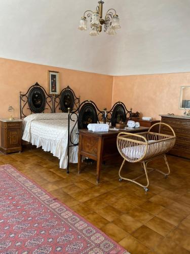 a bedroom with a bed and a desk and chairs at Casa della Resistenza in Sulmona