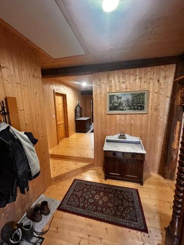 a bathroom with a sink in a room with wooden walls at Wippertaler Hütte in Kleinfurra