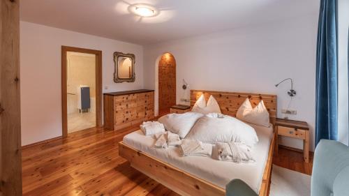 a bedroom with a bed with two dogs laying on it at Villa Santer in Dobbiaco