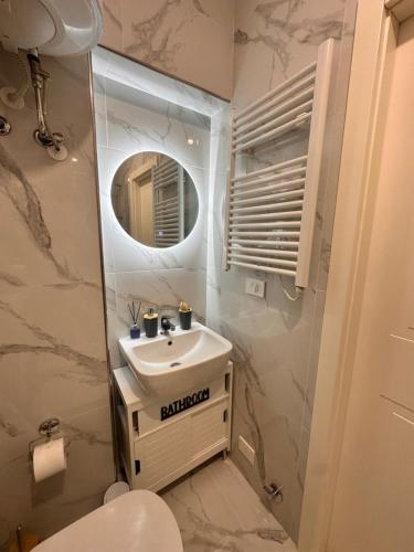 a bathroom with a sink and a mirror at Chez Grenuel in Sanremo