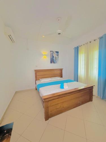 a bedroom with a wooden bed in a room at Apartment For Rent in Ambulgama