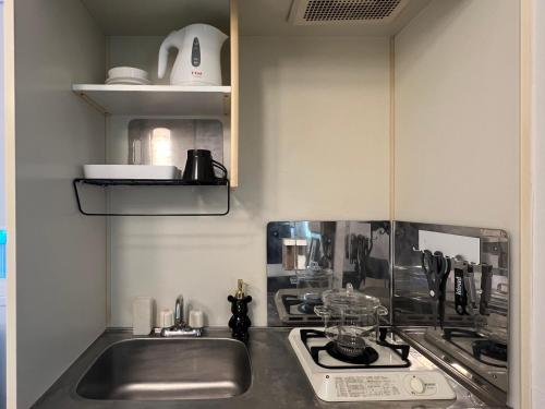 a kitchen with a sink and a stove at Kuro House - In the middle of Hiro, Omotesando, Roppongi in Tokyo