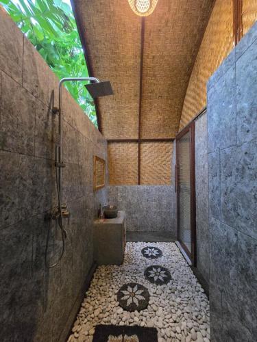 a bathroom with a shower and a sink and a toilet at Eco Moringa Garden in Banyuwedang